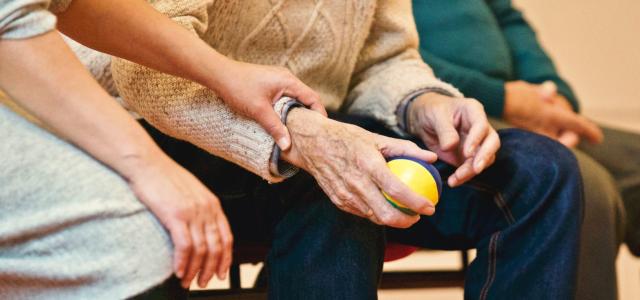 Elderly person holding a stress ball